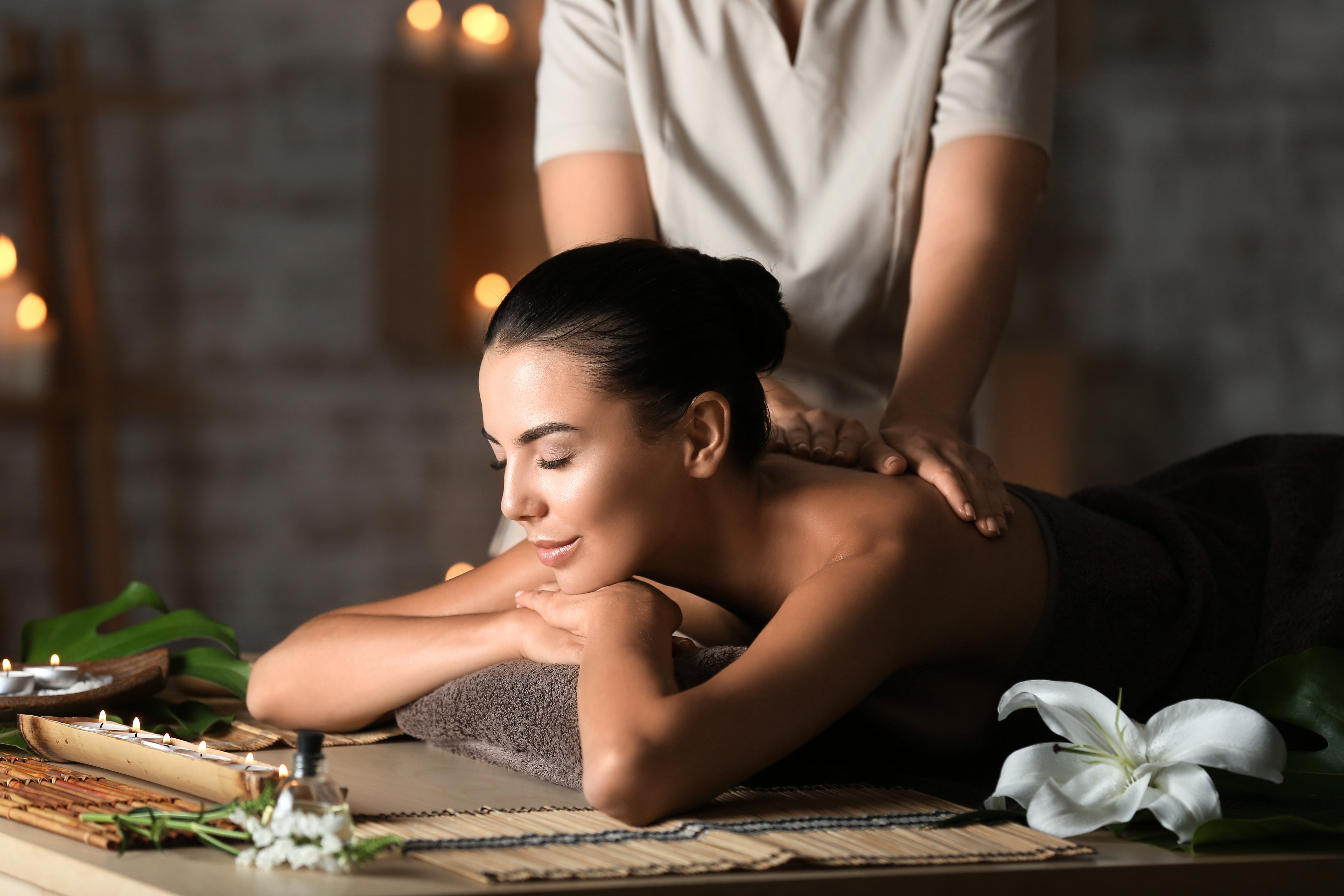 Beautiful Young Woman Receiving Massage in Spa Salon